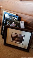 Framed personalized signed print, two shadow boxes with coins and currency, and display box arranged together