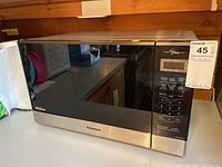 Front view of Panasonic microwave oven showing the model and general condition.