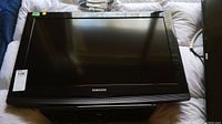 Overall view of the black 32-inch Samsung television in horizontal position.