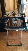 Full view of the Mastercraft table saw on foldable metal stand with saw blade mount visible.