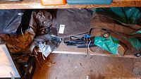 Photo showing a pile of assorted tarps of various colors and sizes stacked together.