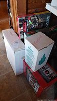 Boxes containing Insider's Express Holiday Express train and battery operated Christmas wreaths, showing packaging and condition.