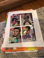 Photo of four TV Guide magazines with different Elvis Presley holographic covers laid out in a white frame.