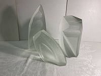 Front view of three abstract studio art glass sculptures showing varying heights and shapes