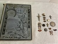 Photo showing 1894 The Pathway of Life hardcover book and assorted religious items including crosses, badges, and a coin