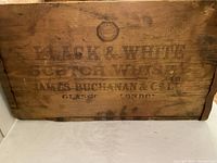 Front side showing stamped Black & White Scotch Whisky branding