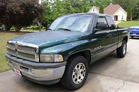 Front three-quarter view, driver's side showing grille, hood, windshield, and part of bed