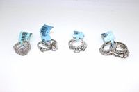 Four sterling silver rings including three ring sets, all size 7, shown with original tags attached.