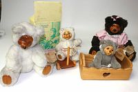 Wide shot showing all 4 Raikes bears including their wood faces, wooden cradle, and wooden scooter accessories.