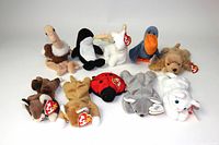 Photo showing front angle of 10 vintage TY Beanie Babies laid out in two rows with original heart tags visible