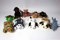 Lot of 10 vintage Ty Beanie Babies including tiger, turtle, monkey, bat, horse, various dogs, and shark, all with original tags.