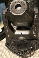 Photo of one PR Lighting XS-250 moving head spotlight with power cables coiled at base.