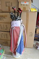 Full view of the Yamaha branded golf bag holding clubs with a towel hanging on the side.