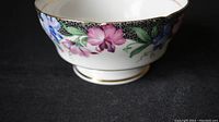 Close-up of tea cup floral pattern and gold trim