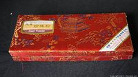 Closed red decorative box labeled 'Pearl Powder'