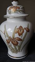 Side view of ginger jar showing floral design and gold trim on lid and body