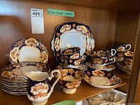 Shelf overview showing all tea set pieces together