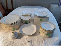 Top-down view of stacked plates and butter dish lid laid out on table
