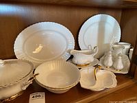 Group shot of all porcelain pieces arranged on shelf