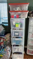 Overall view of Sterilite 5-drawer storage unit with two clear red-lid bins on top