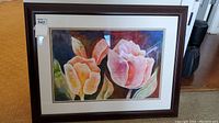Full view of the framed watercolor painting showing two large flowers, matting, and brown wooden frame.
