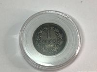 Obverse view of 1885 Austria 1 Kreuzer coin showing denomination and year inside a protective capsule.