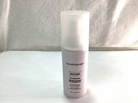 Front view of the Bare Minerals Dew Mist Setting Spray 100ml bottle with label showing product name and size.