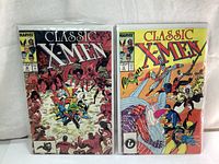 Two Classic X-Men comic books from 1987, issue #12 and #14, shown front cover side by side.