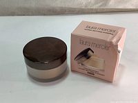 Jar of Laura Mercier Translucent Loose Setting Powder with original box, box shows some wear.