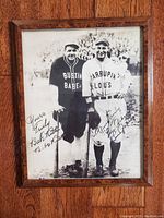 Black-and-white photograph framed print showing two baseball players in vintage uniforms with two signatures.