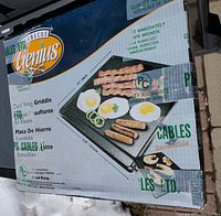 Front of packaging showing image of griddle with food, brand Genius, size 15" x 12.8"