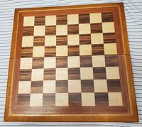 Top view of the wooden chess board showing a 16x16 inch checkered pattern with natural wood colors.