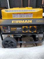 Front view of generator showing control panel with two 120V outlets, one twist-lock receptacle, digital display and model badging