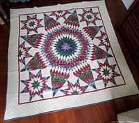 Overhead view of full quilt laid flat on hardwood floor