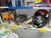 Photo showing HP Photosmart Mini Q3046A printer, cables, new HJC motorcycle helmet, and crocheted items.