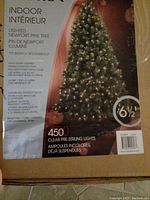 Box of 6.5 ft indoor lighted Newport Pine Christmas Tree showing product details and features including 450 clear pre-strung lights.
