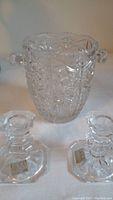 Photo of the crystal ice bucket and two candle holders showing detailed cut designs and handles on ice bucket