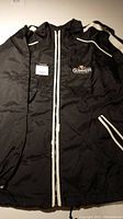 Black vintage style Guinness jacket showing full front with zipper and logo on left chest.