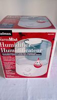 Box of Holmes Warm Mist Humidifier HS-6120C featuring product image, branding, and key features