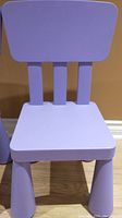 Front view of a single purple children's chair showing seat, backrest, and legs.