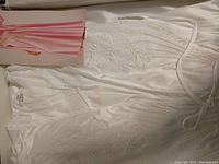 White lingerie top and robe with floral embroidery and satin-like fabric, new in box