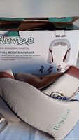 Photo of the Revive MD-207 full body kneading shiatsu massager with its box in the background.