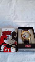 Men's Disney Mickey Mouse wristwatch in box with outer cartoon box cover showing Mickey Mouse face and Disney logo.