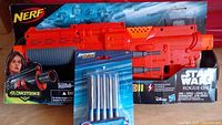 Nerf Glowstrike blaster in box with Star Wars Rogue One branding and included foam darts pack attached to front