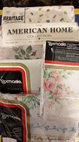 Top view showing packaging and folded sheets for Heritage, American Home Collection, and Texmade sheet sets with floral prints.