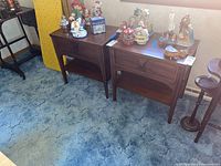 Frontal view of both nightstands with decorative items on top
