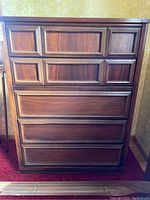 Frontal view of dresser showing six drawers with framed paneling detail