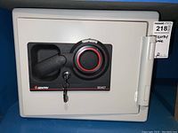 Closed view of Sentry S0407 fire safe front showing combination dial, lever handle, and key lock with two keys inserted.