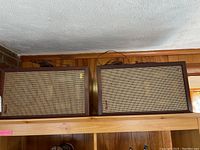 Two rectangular Realistic Electrostat-2 speakers set side by side showing front woven fabric grills and wooden frames.