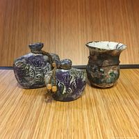 All three pottery pieces arranged together showing shapes, colors, and decorative details